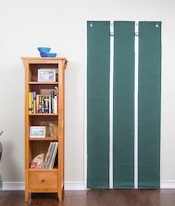 Residential Acoustics AcoustiDoor Soundproof Panel Shown Rolled Down on Standard Size Door in Hunter Green with White Straps