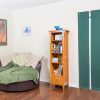 acoustidoor shown in hunter green with white straps is a sound-blocking door panel - shown unbuckled and rolled down - Residential Acoustics